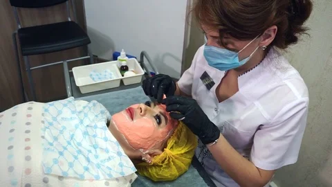 Removing the mask from the woman's face. Stock Footage 77630227