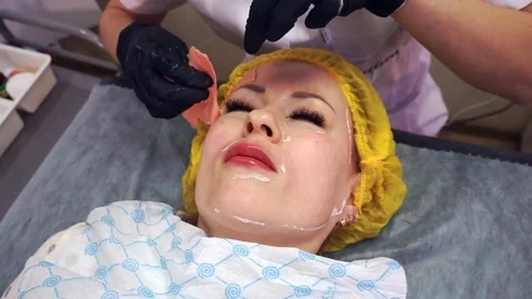 Removing the mask from the woman's face. Video stock 77630254