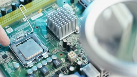 Removing the microprocessor from the circuit board of a desktop computer Stock Footage 169956167