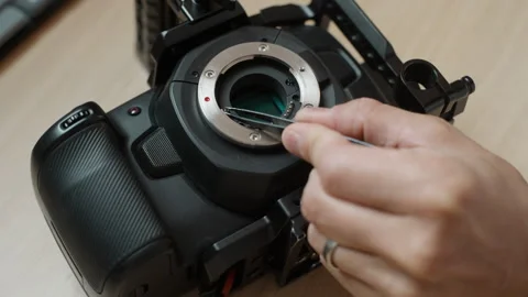 Removing Mount Screws with Tweezers to Access the IR Filter of a Cinema Camera Stock Footage 342754796