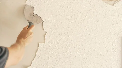 Removing Old Paint from a Wall Stock Footage 117443495