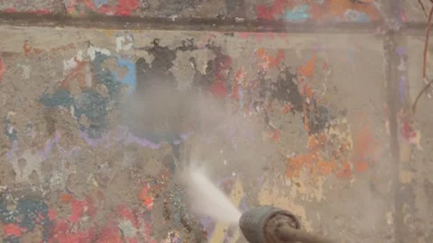 Removing Old Paint from Wall with High-Pressure Cleaner in Slow Motion Stock Footage 348240964