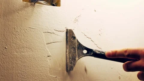 Removing old paint from the wall with a scraper, close-up Stock Footage 146751863
