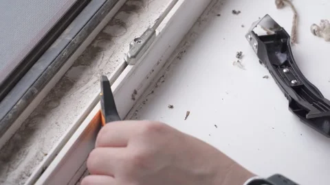 Removing Old Sealant from Window Frame during Renovation 動画素材 335941375