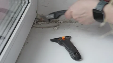 Removing Old Sealant from Window Frame during Renovation 動画素材 335941459