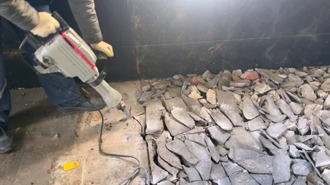Removing old tile from the floor with a electric hammer Video stock 327968486