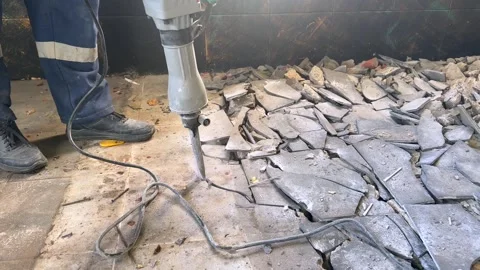Removing old tile from the floor with a electric hammer. Stock Footage 327968492