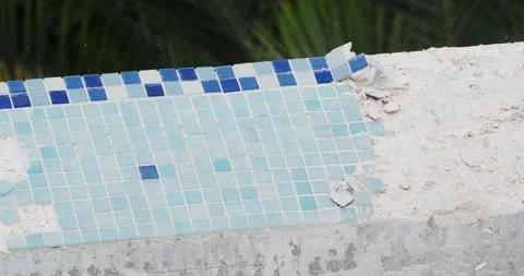 Removing old tile in swimming pool. Pool repairing work. Close-up. Stock Footage 273631920