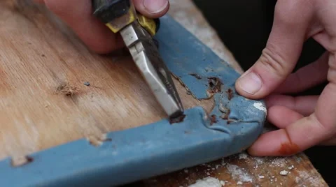 Removing the Old Upholstery. Removing staples. Rebuilding a Chair Seat Stockbeeldmateriaal 59778134