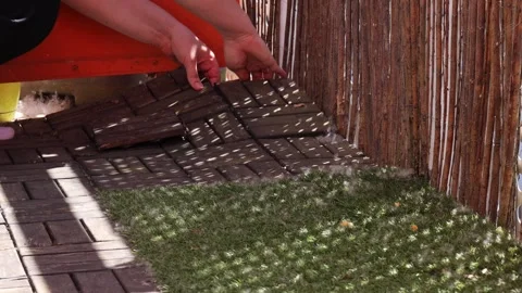 Removing Old Wooden Flooring From Balcony. Hands Lifting Deck Tiles During Video stock 304792152