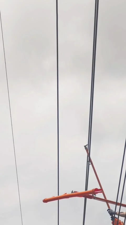 Removing an orange protective line guard from high voltage electrical. Stock Footage 345128547