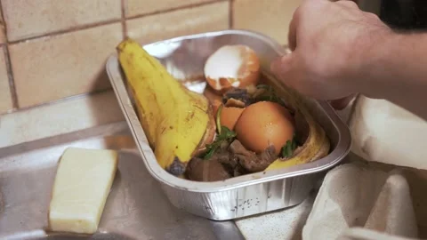 Removing organic compostable food waste for compost Stock Footage 227634893