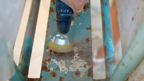 Removing paint and rust from metal surface with round wire brush on grinder Video stock 208446416