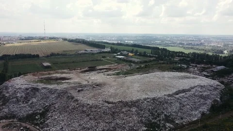 Removing piles of garbage on a field outside the city. Garbage among nature. Stock Footage 137448575