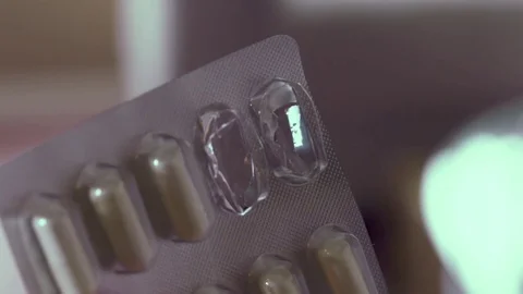 Removing pills from blister pack Stock Footage 75733097