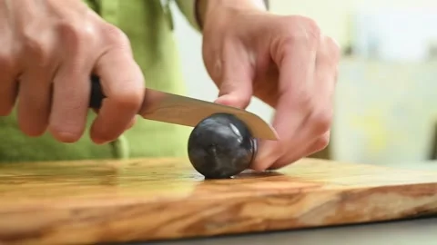 Removing the plum pit. Process of making plum jam. Stock Footage 169799766