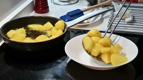 Removing the potatoes from the pan Stock Footage 221355868