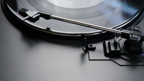 Removing red vinyl record from a turntable - close up of a tone arm Stock Footage 149077704