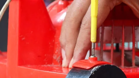 Removing a screw from a plastic electric fan Stock Footage 341536481