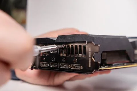 Removing screws from gpu output panel, maintenance, hdmi ports, dp ports, bla Stock Photos