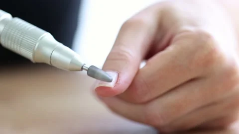 Removing shellac from the nails with fraser. Closeup. Selective focus. 4K Stock Footage 221398849