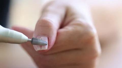 Removing shellac from the nails with fraser. Closeup. Selective focus. 4K Stock Footage 273556049