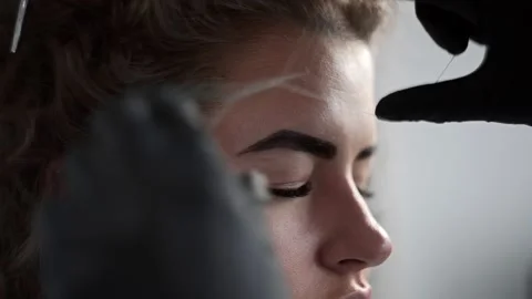 Removing small hairs from face with thread in beauty salon, depilation with Stock Footage 90294837