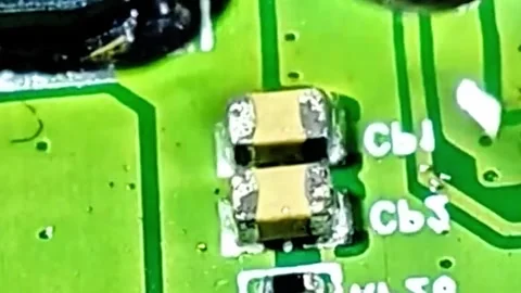 Removing SMD Capacitor from Smartphone PCB Under Microscope Stock Footage 333900090