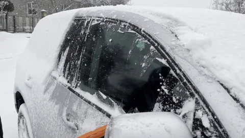 Removing snow off a car window Stock Footage 229966538