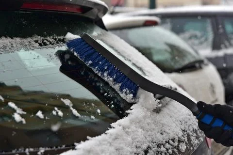 Removing snow from car windshield Photos