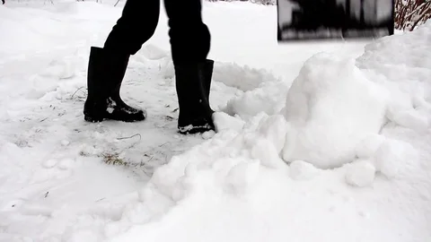 Removing snow in the garden Stock Footage 72476291