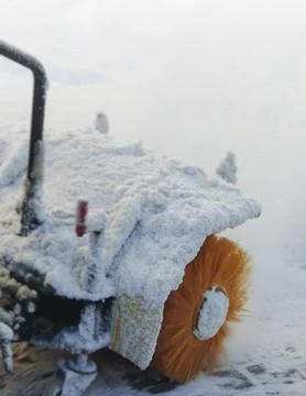 Removing snow with portable blower machine during winter, worker with gas s.. Fotos de archivo