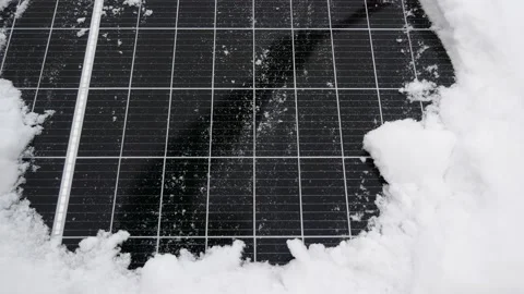 Removing snow from the solar panel. The solar element under the snow. Video stock 146609377