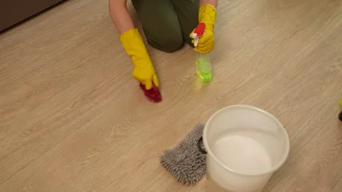 Removing stains at home. Using a spray bottle with disinfectant in the house Stockbeeldmateriaal 311051246