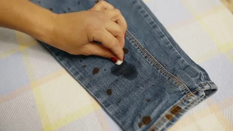 Removing stains from the surface of denim pants with a special tool Stock Footage 202047868