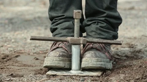 Removing stave from ground Stock Footage 77047916