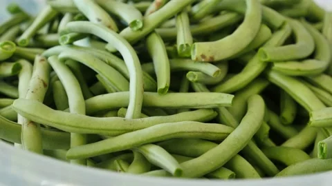 Removing stiff threads and bones of green fresh beans, bean meal preparation, Stock Footage 137764724