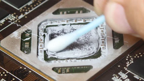Removing thermal pasta from GPU chip with cotton swab. Close up macro Video stock 136984497