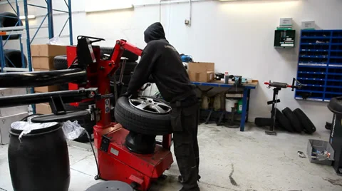 Removing a tire from the rim with a machine Stock Footage 36353959
