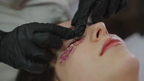 Removing under-eye patches after eyelash lamination treatment Stock Footage 332338193