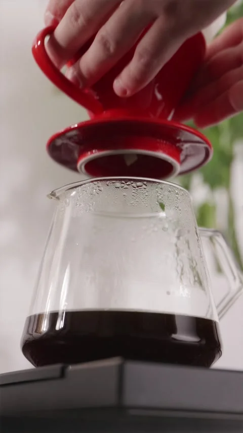 Removing V60 dripper from glass server tilt-up shot Stock Footage 332720149