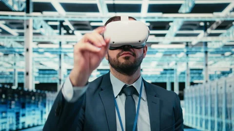 Removing VR goggles, finishing task and software developer in data center Stock Footage 329650461