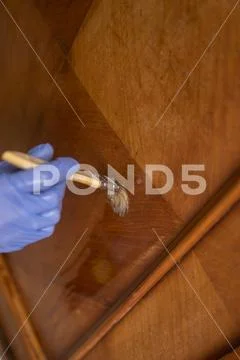 Removing wax from old furniture Stock Photos
