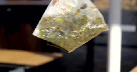 Removing a wet green tea bag after brewing Stock Footage 345919160