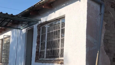 Removing window from derelict building. Hand held. Video stock 252343787