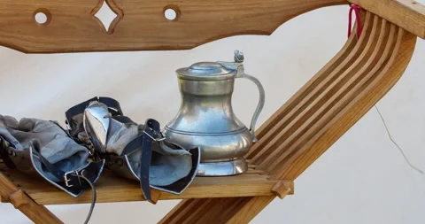 Renaissance armor gloves and silverware carved chair Savonarola style. Stock Footage 205481378