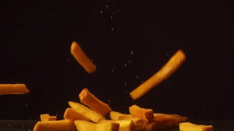 Rench Fries Falling in Slow Motion Against Dark Background Crispy Fast Food Stock Footage 334268281