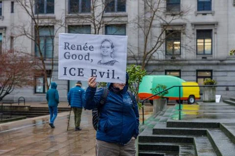 Rene Good ICE Evil protest sign with portrait held by demonstrator in blue .. Stock Photos