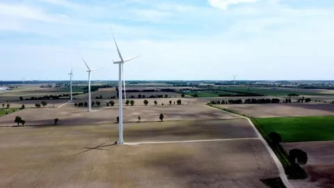 Renewable energy being generated by wind turbines on farmland creating Stock-Footage 159608966