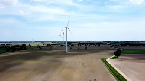 Renewable energy being generated by wind turbines on farmland creating Stock-Footage 159609409